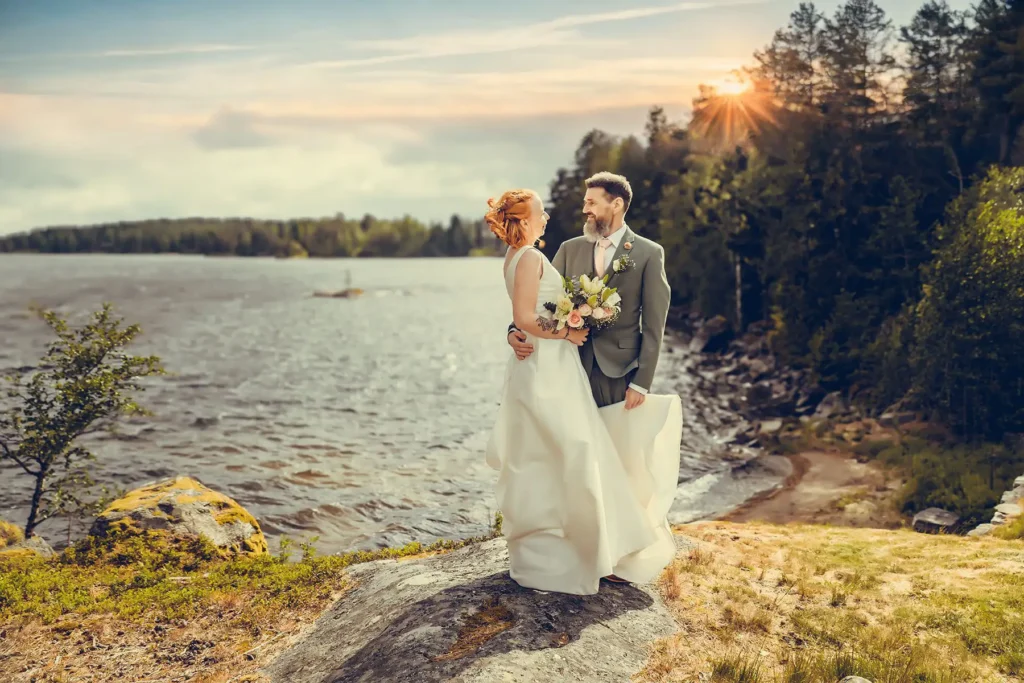 Bryllupsfotograf Oslo – brudepar ved vann omgitt av skog og gyllent kveldslys